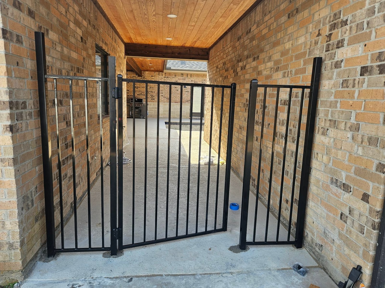 Black metal gate installation
